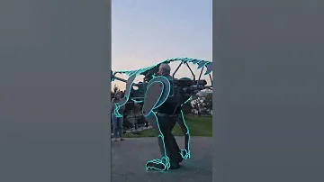 Man is wearing an LED T-Rex mechanical suit and strutting through the park!